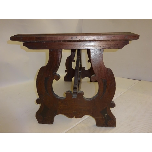 253 - Antique oak pugin style occasional table raised on end supports and cross stretcher. W. 130cm, D. 58... 