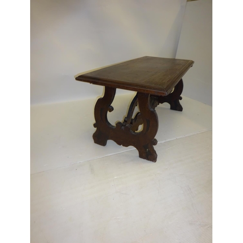 253 - Antique oak pugin style occasional table raised on end supports and cross stretcher. W. 130cm, D. 58... 