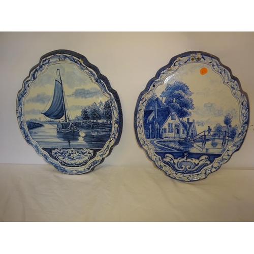 29 - A pair of old blue and white oval shaped porcelain wall plaques with river scenes. H. 38cm x 32cm. (... 