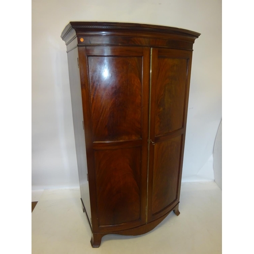 325 - Antique mahogany bow shaped wardrobe having panel doors and raised on splay feet. W. 100cm, H. 173cm... 