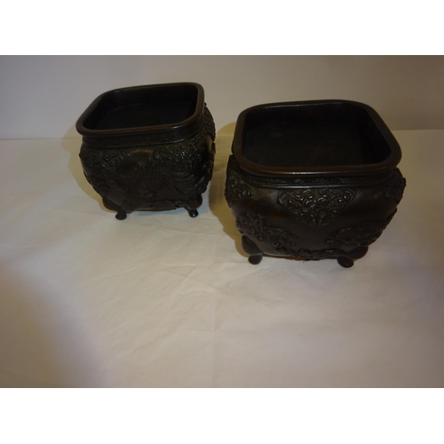33 - A pair of small size Chinese jardineres raised on feet.  9cm x 9cm.