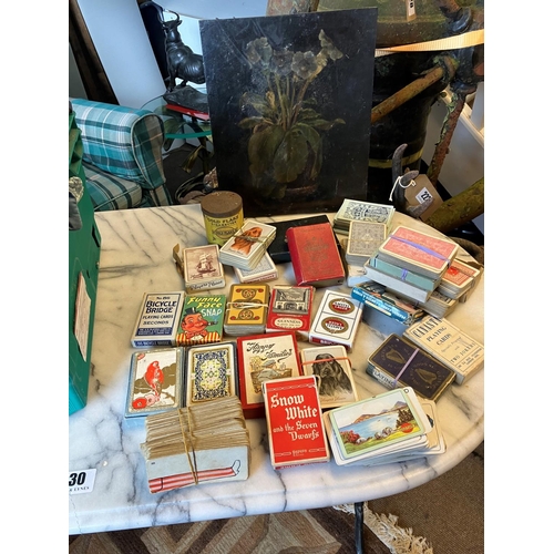 339 - Boxed lot of painting on board and a collection of playing cards.