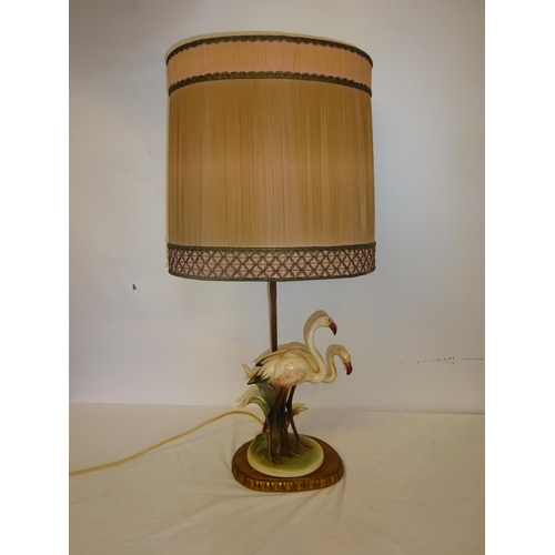 37 - An attractive side lamp in the form of two china flamingo's and old pleated shade. Overall height 68... 
