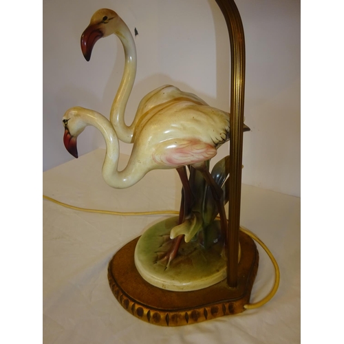 37 - An attractive side lamp in the form of two china flamingo's and old pleated shade. Overall height 68... 