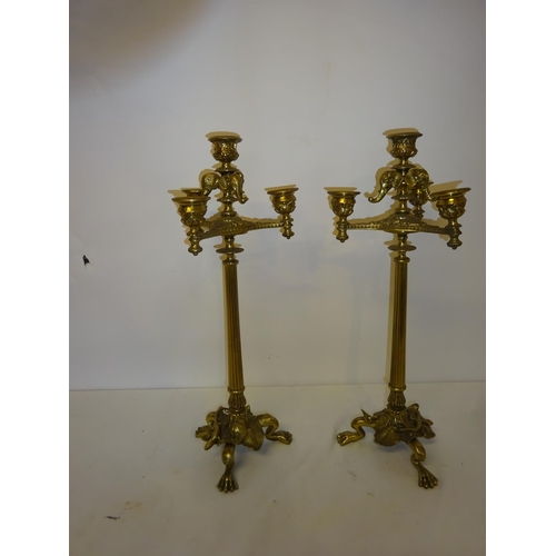 38 - A pair of tall brass 3 branch candleabra. H. 43cm.