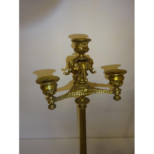 38 - A pair of tall brass 3 branch candleabra. H. 43cm.