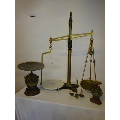 39 - A large antique brass & metal counter top scales and 3 smaller scales. (Height of large scales 88cm)... 