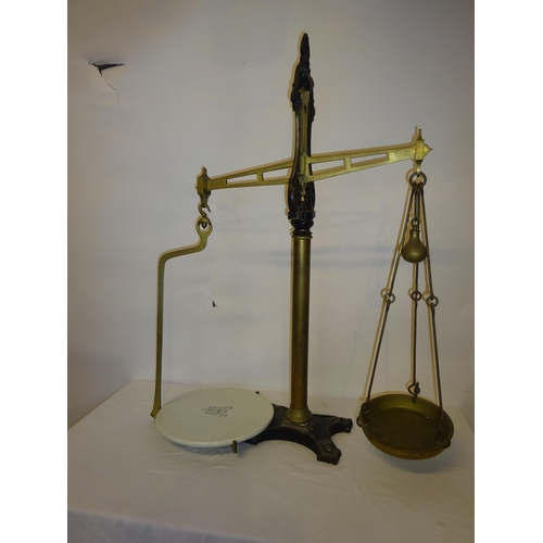 39 - A large antique brass & metal counter top scales and 3 smaller scales. (Height of large scales 88cm)... 