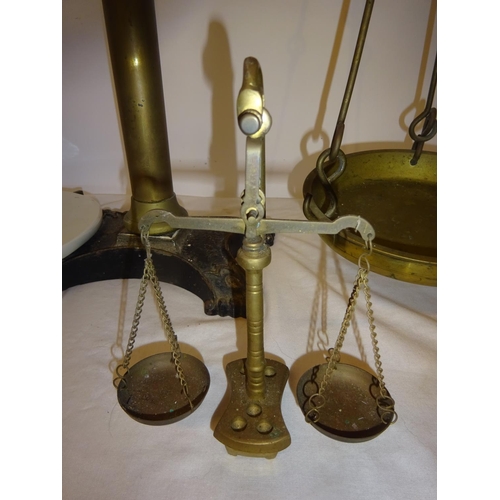 39 - A large antique brass & metal counter top scales and 3 smaller scales. (Height of large scales 88cm)... 