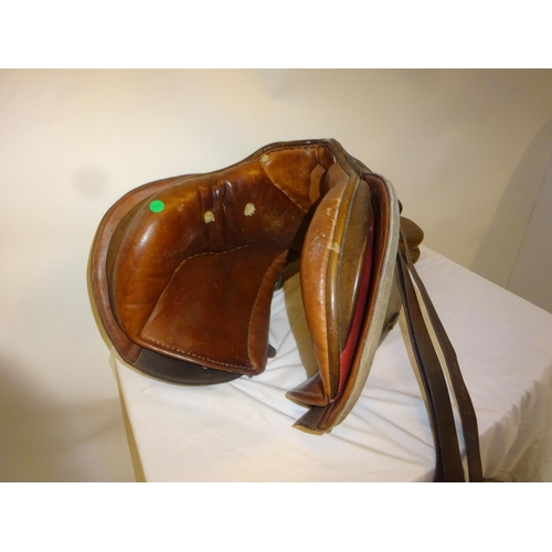 54 - Leather saddle and a harness mirror.