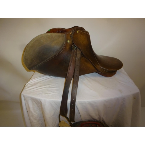 54 - Leather saddle and a harness mirror.