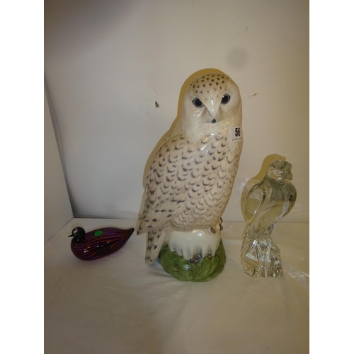 56 - Large china snowy owl by Royal Copenhagen, H. 41cm together with a Baccarat crystal eagle perched on... 