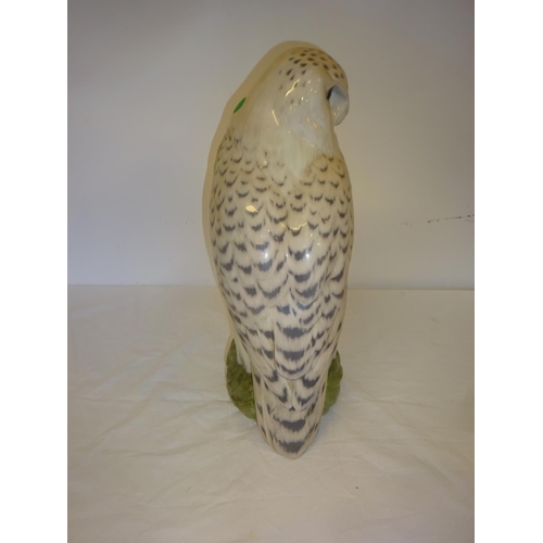 56 - Large china snowy owl by Royal Copenhagen, H. 41cm together with a Baccarat crystal eagle perched on... 