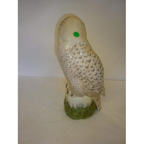 56 - Large china snowy owl by Royal Copenhagen, H. 41cm together with a Baccarat crystal eagle perched on... 