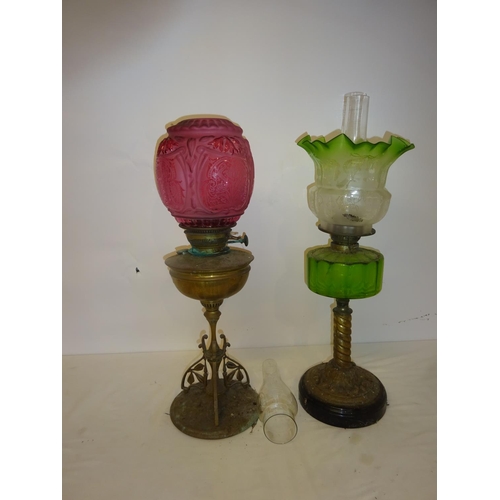 60 - Two Victorian oil lamps with oil glass shades (chip on rim of green shade and green bowl cracked).