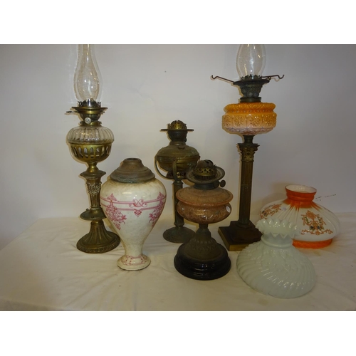 68 - A collection of 5 old oil lamps and some shades (some damage).