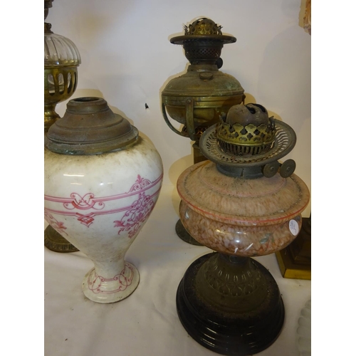 68 - A collection of 5 old oil lamps and some shades (some damage).