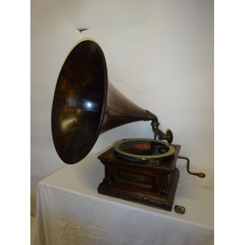 75 - A good antique carved oak cased gramophone with rare timber horn in working order.