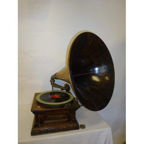 75 - A good antique carved oak cased gramophone with rare timber horn in working order.