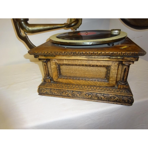 75 - A good antique carved oak cased gramophone with rare timber horn in working order.