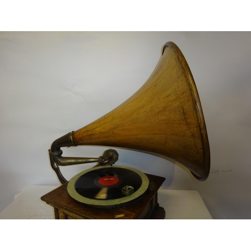 75 - A good antique carved oak cased gramophone with rare timber horn in working order.