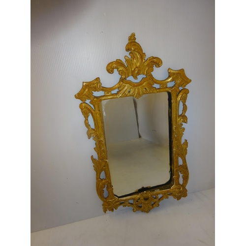 80 - Decorative carved wood and gilded mirror. 80cm x 40cm approx.