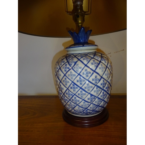 83 - A pair of blue china side lamps and shades. Overall height 55cm.