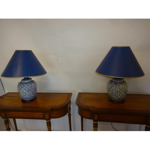 83 - A pair of blue china side lamps and shades. Overall height 55cm.