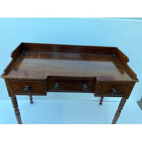 368 - A 19th century mahogany (Cork) side table having a tray back and fitted with three drawers. W. 118cm... 