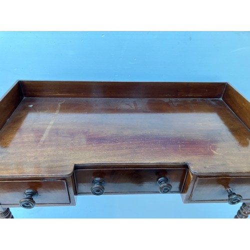 368 - A 19th century mahogany (Cork) side table having a tray back and fitted with three drawers. W. 118cm... 