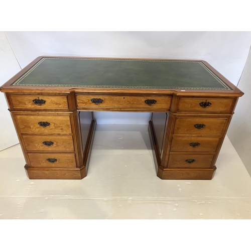 104 - An excellent quality cherry wood pedestal desk, the shaped top having tooled leather inset and the e... 