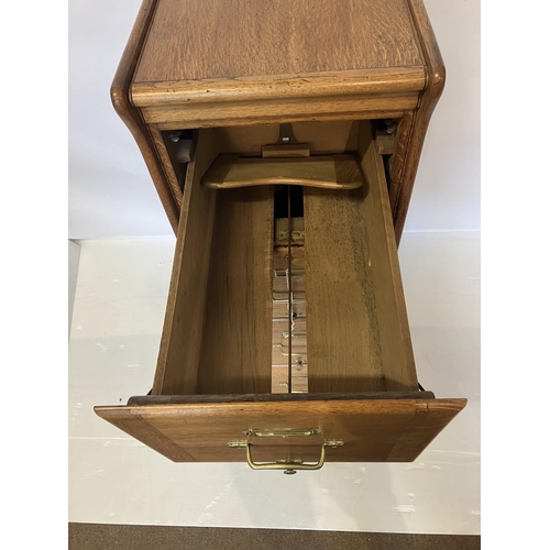 105 - A good antique oak filing cabinet fitted with 4 drawers and having panelled sides and back. H. 135cm... 