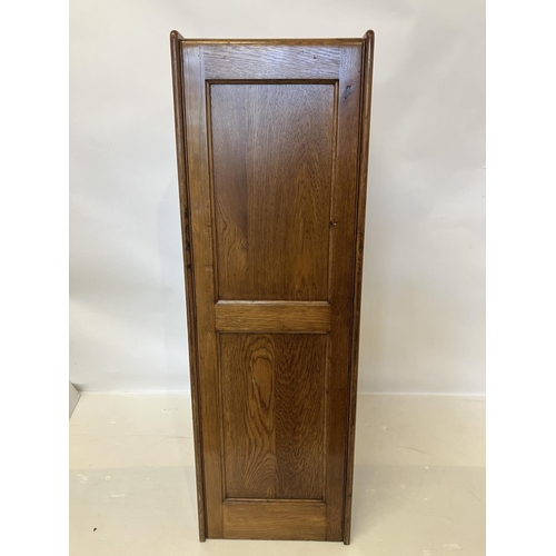 105 - A good antique oak filing cabinet fitted with 4 drawers and having panelled sides and back. H. 135cm... 