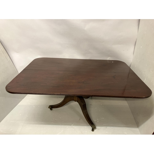 121 - A large Georgian mahogany dining table, the rectangular shaped top with reeded edge and raised on ce... 