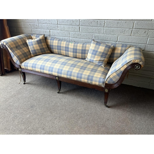 129 - A large Regency mahogany couch having reeded decoration with brass mounts and nicely upholstered. (s... 