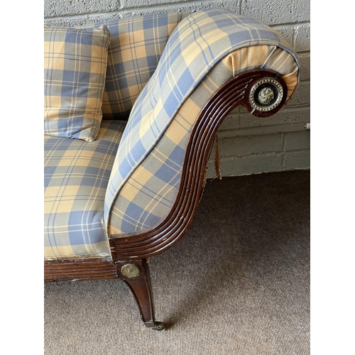 129 - A large Regency mahogany couch having reeded decoration with brass mounts and nicely upholstered. (s... 