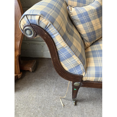 129 - A large Regency mahogany couch having reeded decoration with brass mounts and nicely upholstered. (s... 