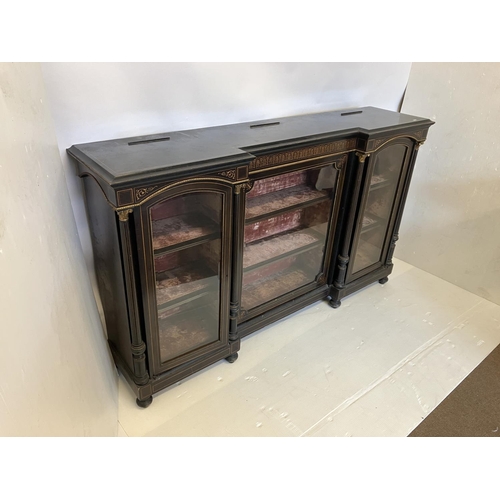 134 - A good 19th century inlaid and ebonized side cabinet having a large centre door and two arched top s... 