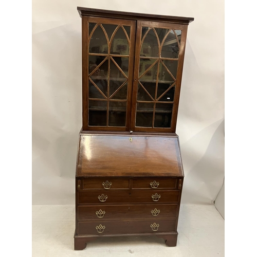 226 - Georgian mahogany bureau bookcase having a well fitted interior, 2 short and 3 long drawers and rais... 