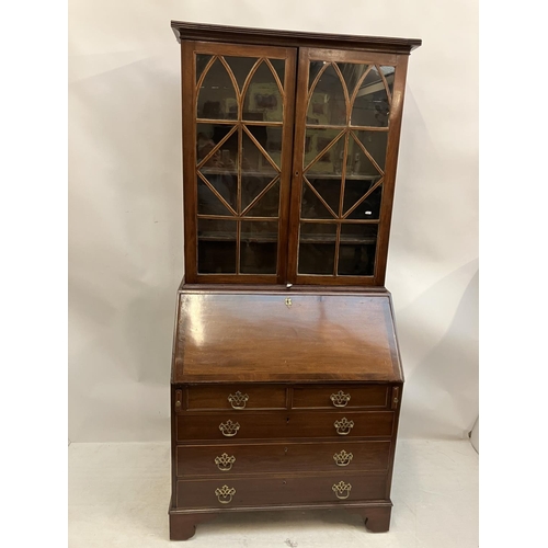 226 - Georgian mahogany bureau bookcase having a well fitted interior, 2 short and 3 long drawers and rais... 