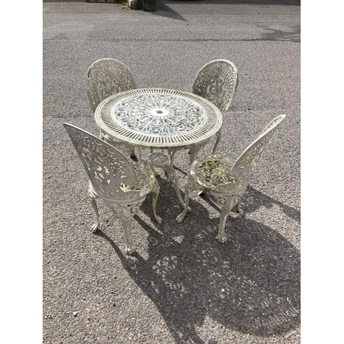 237 - A cast aluminium circular garden table and four chairs.