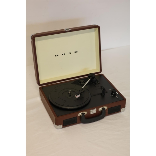 24 - A Bush portable record player and a quantity of records.