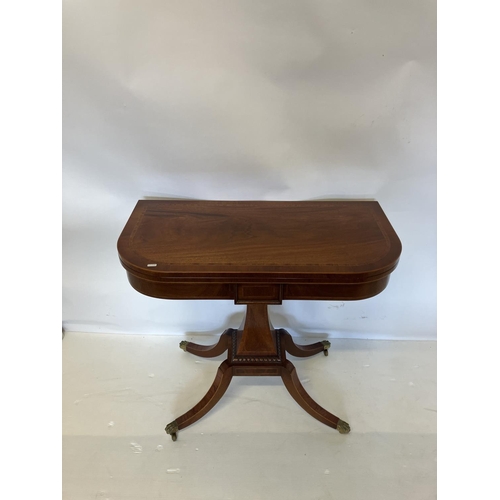 247 - A fine quality Regency style mahogany tea/card table, the D shaped folding top raised on tapered col... 