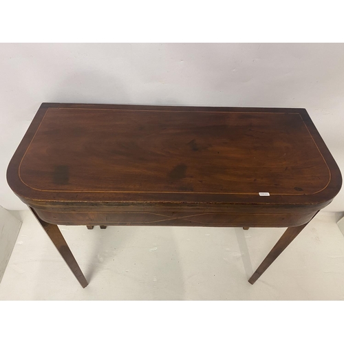 258 - An Irish Georgian inlaid mahogany card table, the D shaped folding top raised on tapered legs. W. 90... 