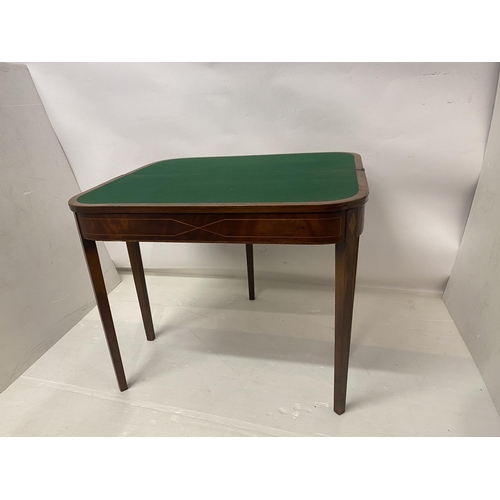 258 - An Irish Georgian inlaid mahogany card table, the D shaped folding top raised on tapered legs. W. 90... 