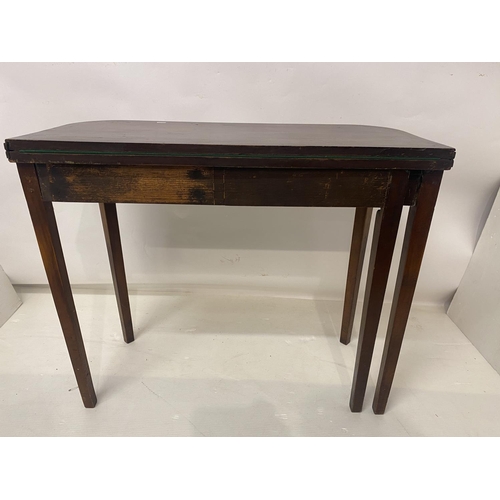 258 - An Irish Georgian inlaid mahogany card table, the D shaped folding top raised on tapered legs. W. 90... 