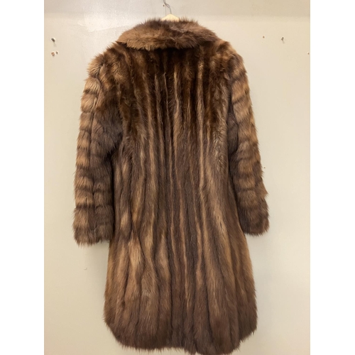 265 - A full length fur coat with label, Jean Desses, Paris. Approx. length 135cm.