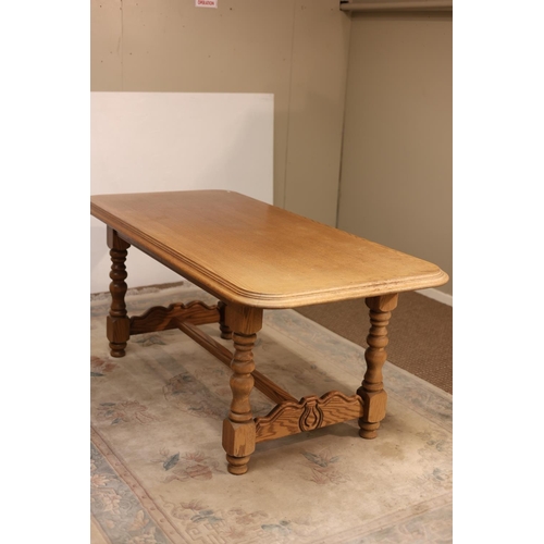 278 - Oak rectangular shaped dining table raised on turned legs with cross stretcher. L. 180cm, W. 88cm.