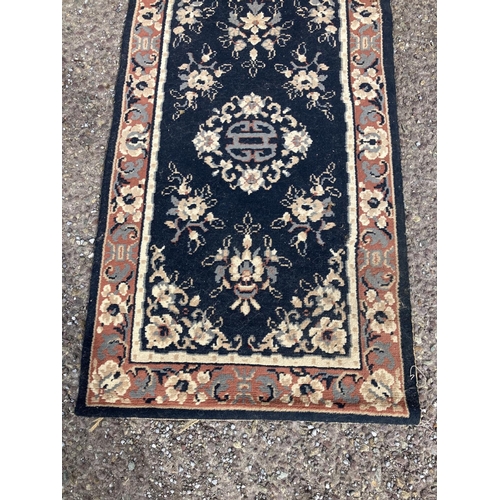 298 - Neat sized runner rug. 235cm x 60cm approx.