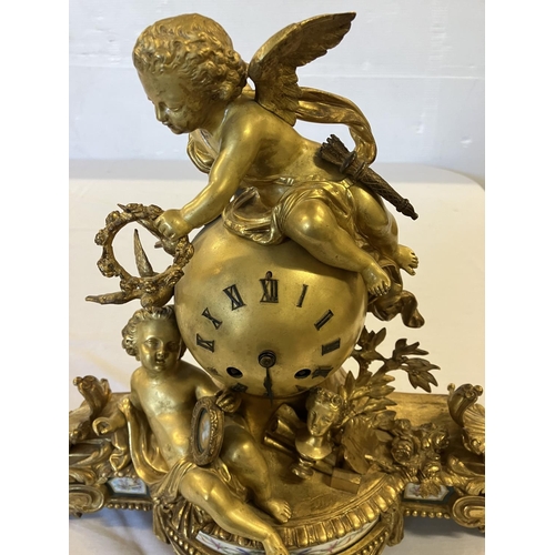 307 - A fine 19th century gilded brass mantle clock, the clock decorated with cherub figures and porcelain... 